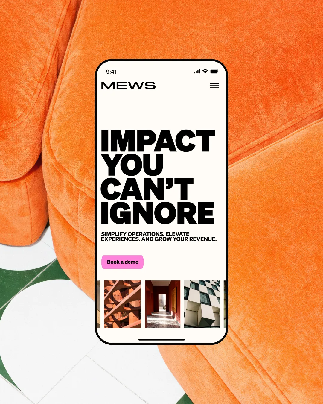 Mews hotel software platform displayed on a smartphone screen against an orange textured background, showing the rebrand with bold "Impact you can't ignore" headline and a pink "Book a demo" button